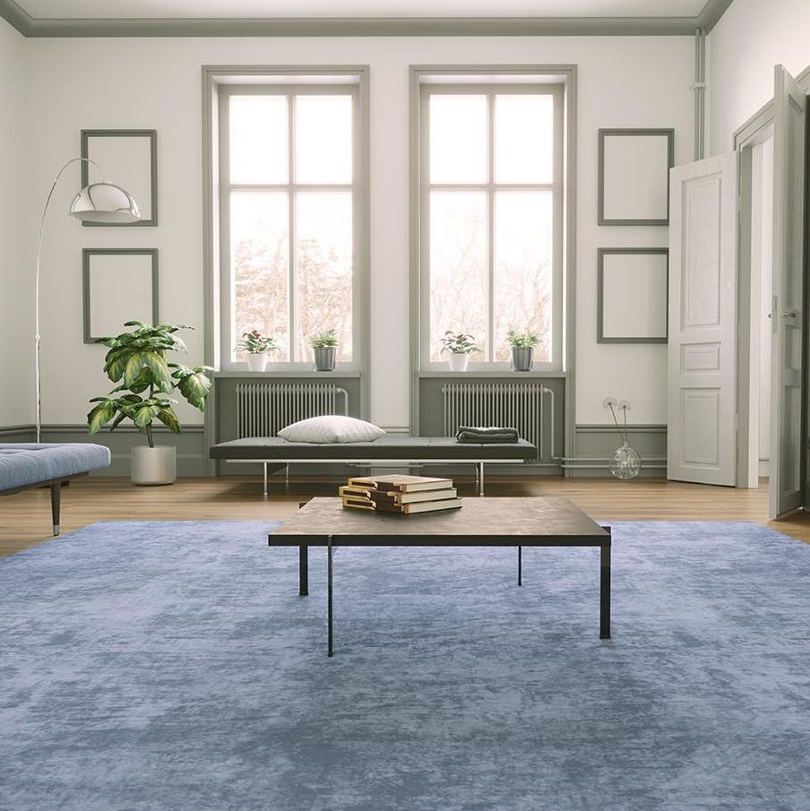 a blue area carpet adds color and softness to a living room