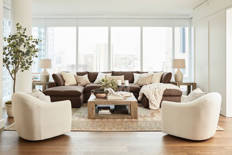 ayesha curry home tour living room with brown sofa and white armchairs ayesha curry home tour living room with brown sofa and white armchairs